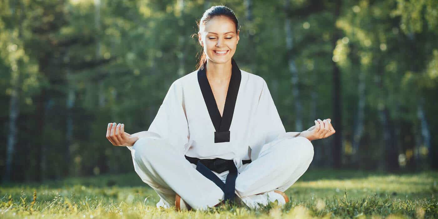 Martial Arts Lessons for Adults in MI MI - Happy Woman Meditated Sitting Background